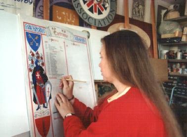 Fiona writing on an illuminated vellum piece